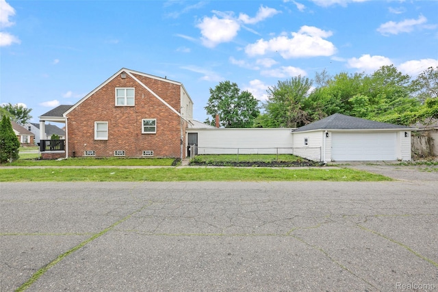 19215 Winthrop St, Dearborn, MI 48235 - view of property exterior featuring a detached garage and brick siding