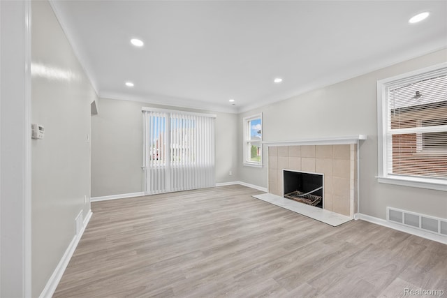 19215 Winthrop St, Dearborn, MI 48235 - unfurnished living room featuring baseboards, wood finished floors, a tile fireplace, crown molding, and recessed lighting