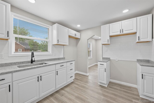 19215 Winthrop St, Dearborn, MI 48235 - kitchen featuring a sink, tasteful backsplash, baseboards, recessed lighting, and light wood finished floors