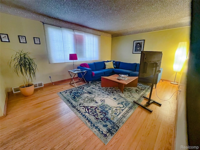 21710 Parklawn St, Oak Park, MI 48237 - living area with a textured ceiling, wood finished floors, and baseboards