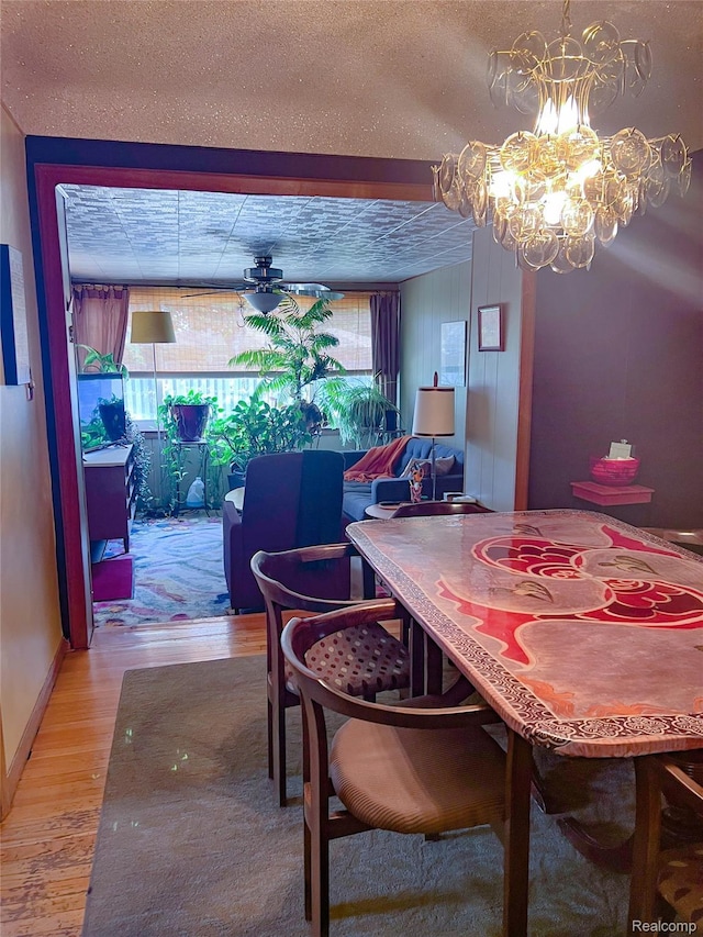 21710 Parklawn St, Oak Park, MI 48237 - dining area with light wood-style floors, a chandelier, and a textured ceiling
