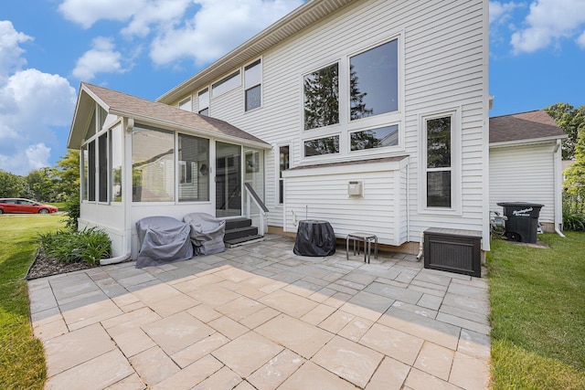 6533 Cannon Farms Dr NE, Rockford, MI 49341 - rear view of property with a patio, a sunroom, a lawn, and entry steps