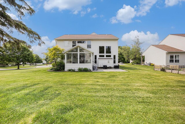 6533 Cannon Farms Dr NE, Rockford, MI 49341 - rear view of property featuring a lawn, a sunroom, and a patio