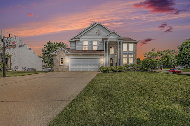 6533 Cannon Farms Dr NE, Rockford, MI 49341 - greek revival house featuring concrete driveway, an attached garage, a front lawn, and brick siding