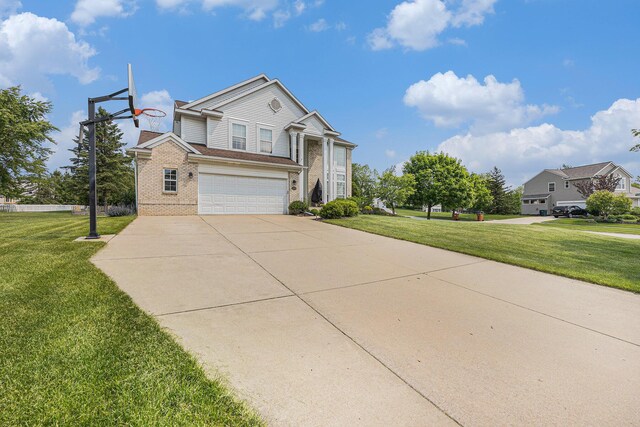 6533 Cannon Farms Dr NE, Rockford, MI 49341 - view of front of property featuring brick siding, a garage, a front yard, and concrete driveway