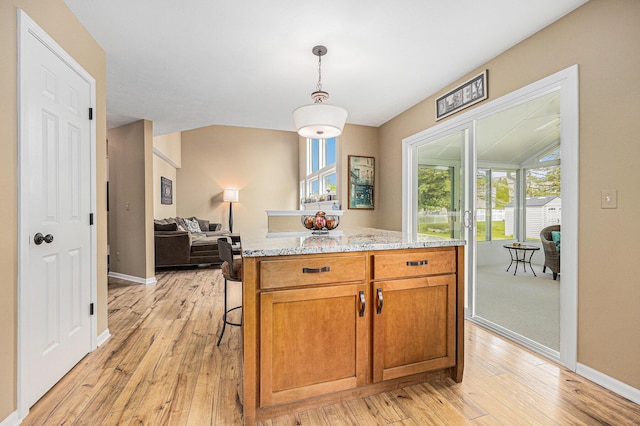 6533 Cannon Farms Dr NE, Rockford, MI 49341 - kitchen with light wood-style floors, pendant lighting, and baseboards