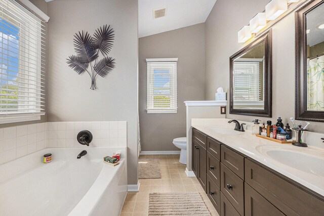 6533 Cannon Farms Dr NE, Rockford, MI 49341 - full bathroom with double vanity, toilet, a bath, tile patterned floors, and baseboards