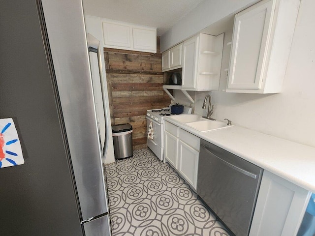 661 W Michigan Rd, Twin Lake, MI 49457 - kitchen with stainless steel appliances, wooden walls, a sink, white cabinetry, and open shelves