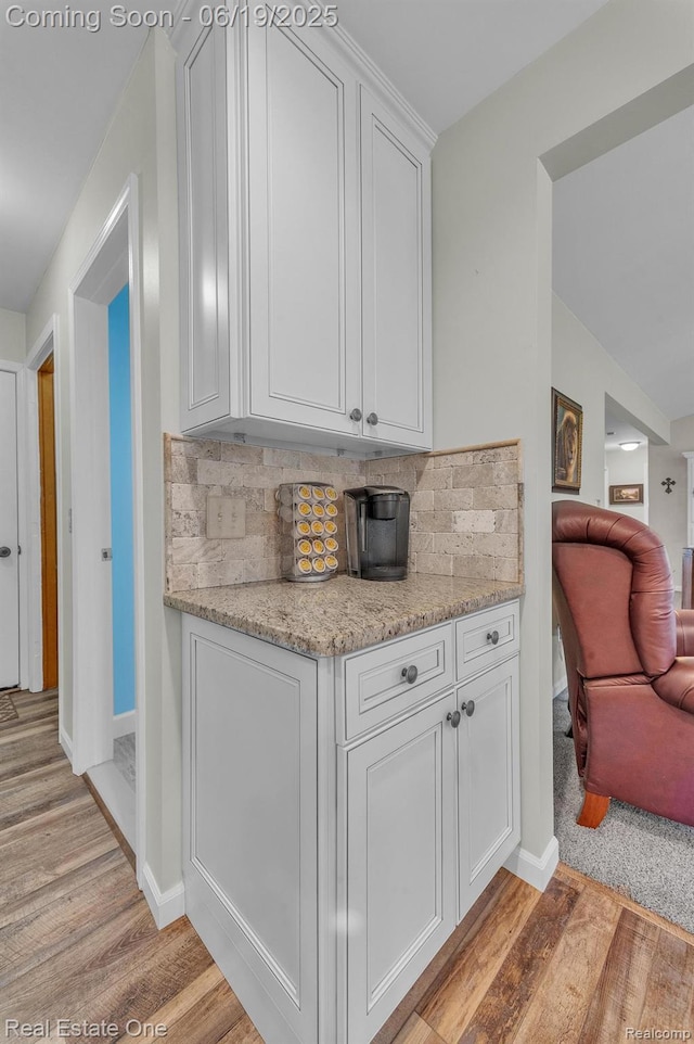 15719 Greenview, Fraser, MI 48026 - kitchen with light wood-style flooring, backsplash, white cabinetry, and light stone countertops