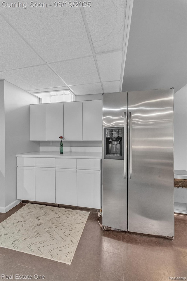 15719 Greenview, Fraser, MI 48026 - kitchen featuring stainless steel fridge, white cabinetry, a paneled ceiling, and light countertops
