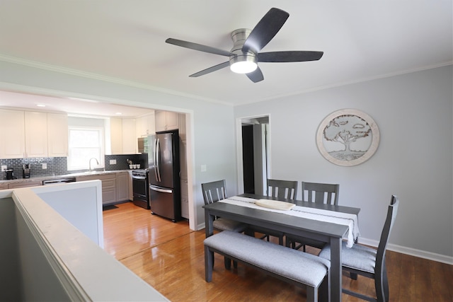 2524 N Mckinley Rd, Flushing, MI 48433 - dining area with a ceiling fan, light wood-style flooring, ornamental molding, and baseboards