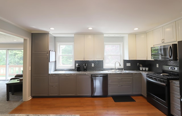 2524 N Mckinley Rd, Flushing, MI 48433 - kitchen with stainless steel appliances, a sink, gray cabinets, decorative backsplash, and ornamental molding