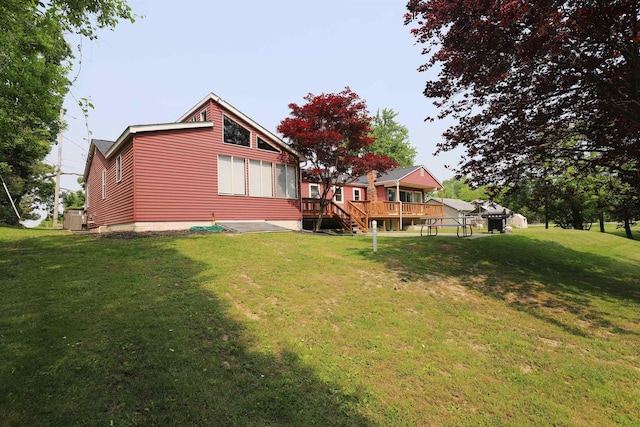 2524 N Mckinley Rd, Flushing, MI 48433 - rear view of property featuring a deck, cooling unit, and a yard
