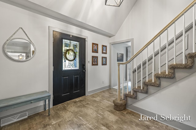 6872 Forest Valley Dr SE, Grand Rapids, MI 49546 - entryway featuring stairway, wood finished floors, baseboards, and vaulted ceiling