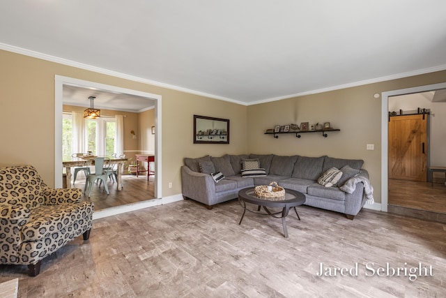 6872 Forest Valley Dr SE, Grand Rapids, MI 49546 - living area featuring crown molding, wood finished floors, a barn door, and baseboards
