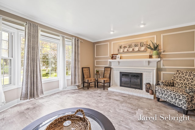 6872 Forest Valley Dr SE, Grand Rapids, MI 49546 - living area with crown molding, wood finished floors, a fireplace, and baseboards