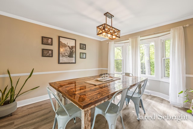6872 Forest Valley Dr SE, Grand Rapids, MI 49546 - dining space with wood finished floors, ornamental molding, baseboards, and a chandelier