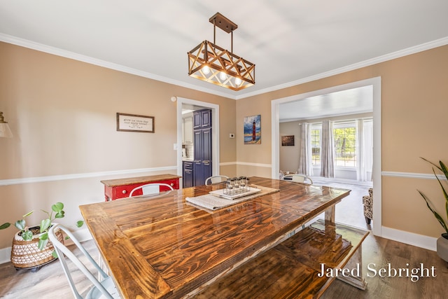 6872 Forest Valley Dr SE, Grand Rapids, MI 49546 - dining room featuring wood finished floors, crown molding, a chandelier, and baseboards