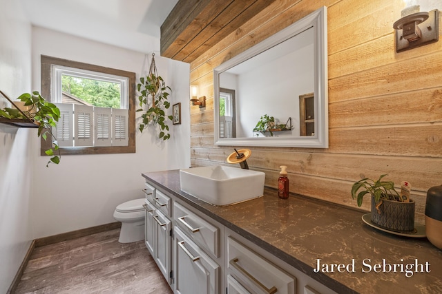 6872 Forest Valley Dr SE, Grand Rapids, MI 49546 - bathroom featuring vanity, toilet, wood finished floors, baseboards, and wood walls
