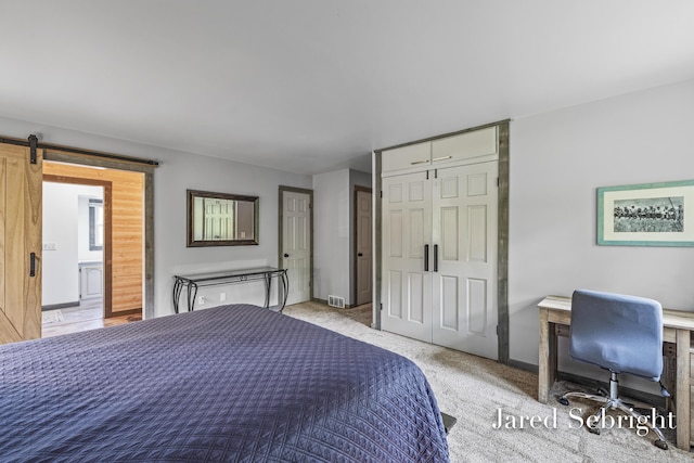 6872 Forest Valley Dr SE, Grand Rapids, MI 49546 - bedroom with a barn door, a closet, and baseboards
