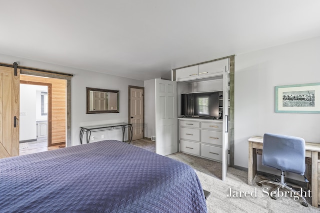 6872 Forest Valley Dr SE, Grand Rapids, MI 49546 - bedroom featuring baseboards, a barn door, and light carpet