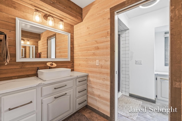 6872 Forest Valley Dr SE, Grand Rapids, MI 49546 - bathroom featuring wooden walls, vanity, and wood finished floors