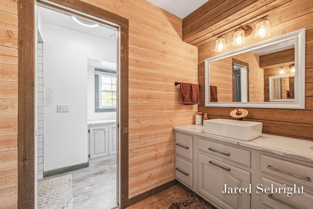 6872 Forest Valley Dr SE, Grand Rapids, MI 49546 - bathroom with wood walls, vanity, and wood finished floors