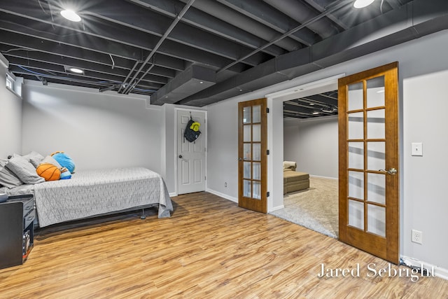 6872 Forest Valley Dr SE, Grand Rapids, MI 49546 - bedroom with french doors, wood finished floors, and baseboards