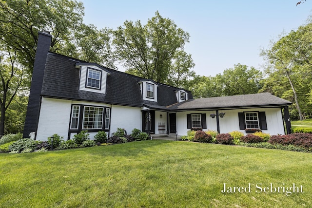 6872 Forest Valley Dr SE, Grand Rapids, MI 49546 - view of front of home with a chimney, brick siding, a front yard, and roof with shingles