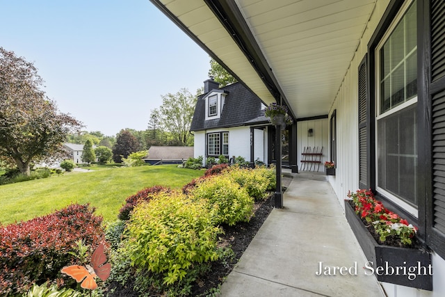 6872 Forest Valley Dr SE, Grand Rapids, MI 49546 - property entrance with a yard, board and batten siding, and a chimney