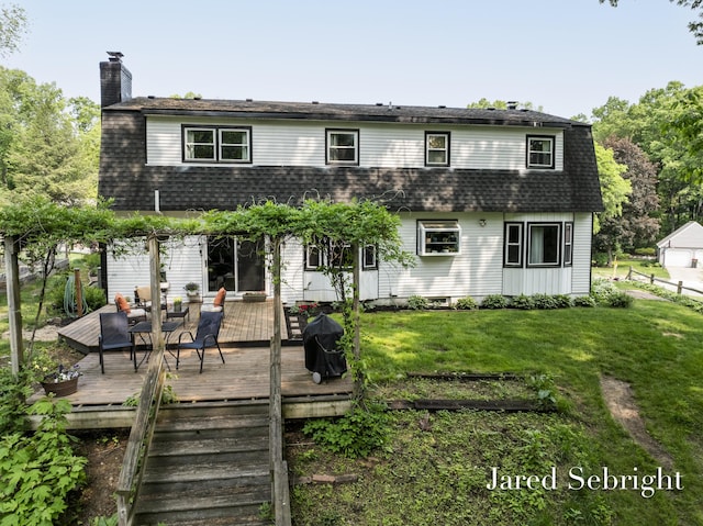6872 Forest Valley Dr SE, Grand Rapids, MI 49546 - back of house featuring roof with shingles, a lawn, a chimney, and a deck