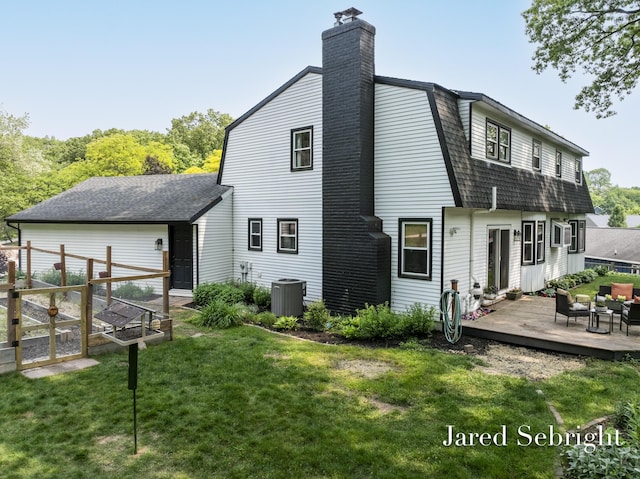 6872 Forest Valley Dr SE, Grand Rapids, MI 49546 - back of house featuring a gambrel roof, a deck, a shingled roof, a chimney, and cooling unit
