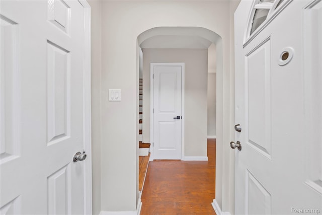 3951 Devonshire Rd, Detroit, MI 48224 - hall featuring dark wood-type flooring, baseboards, and arched walkways