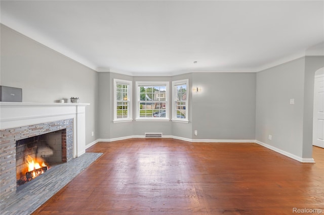 3951 Devonshire Rd, Detroit, MI 48224 - unfurnished living room featuring a fireplace, wood finished floors, baseboards, and ornamental molding