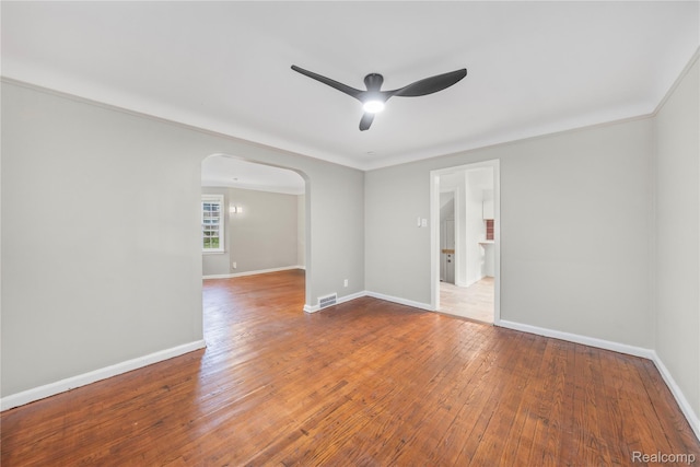3951 Devonshire Rd, Detroit, MI 48224 - unfurnished room featuring arched walkways, ceiling fan, hardwood / wood-style floors, and baseboards