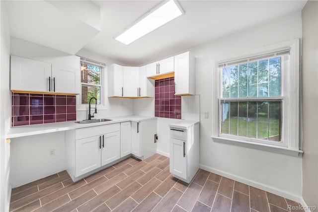 3951 Devonshire Rd, Detroit, MI 48224 - kitchen with a sink, light wood-type flooring, decorative backsplash, and white cabinetry