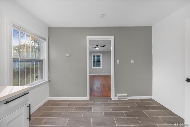 3951 Devonshire Rd, Detroit, MI 48224 - unfurnished dining area featuring baseboards, plenty of natural light, and a ceiling fan