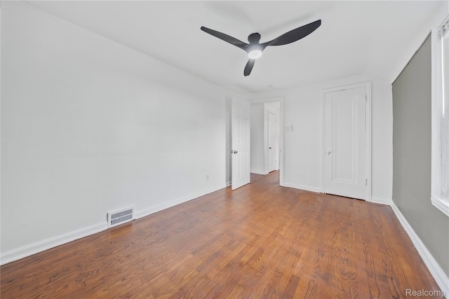 3951 Devonshire Rd, Detroit, MI 48224 - unfurnished bedroom featuring baseboards, wood finished floors, and a ceiling fan