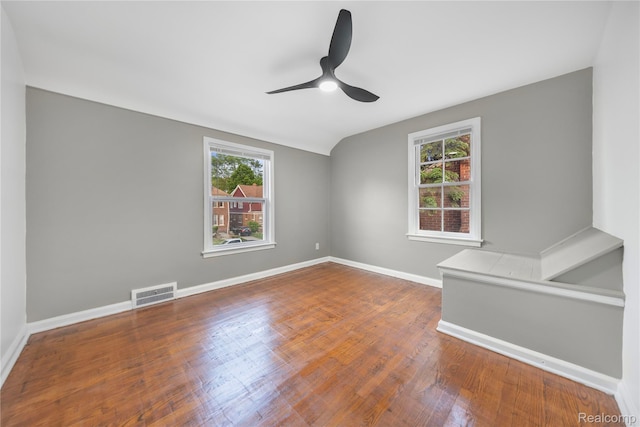 3951 Devonshire Rd, Detroit, MI 48224 - unfurnished room featuring a ceiling fan, wood finished floors, baseboards, and vaulted ceiling