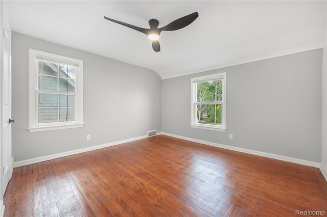 3951 Devonshire Rd, Detroit, MI 48224 - empty room with a ceiling fan, plenty of natural light, wood finished floors, baseboards, and vaulted ceiling