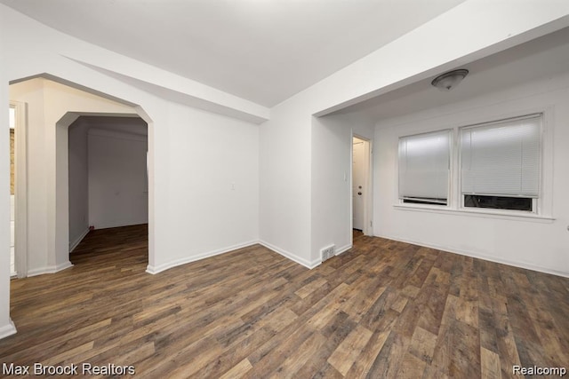 17187 Vaughan St, Detroit, MI 48219 - empty room featuring arched walkways, wood finished floors, and baseboards