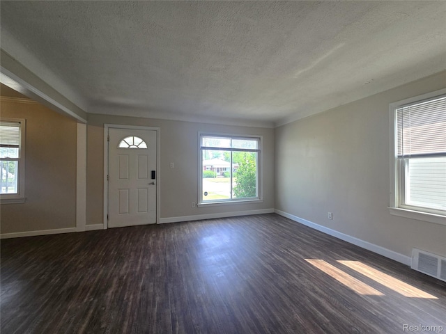 29263 Barton St, Garden City, MI 48135 - entryway featuring a textured ceiling, dark wood-type flooring, and healthy amount of natural light