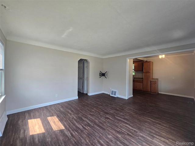 29263 Barton St, Garden City, MI 48135 - unfurnished room featuring dark wood-style floors and arched walkways