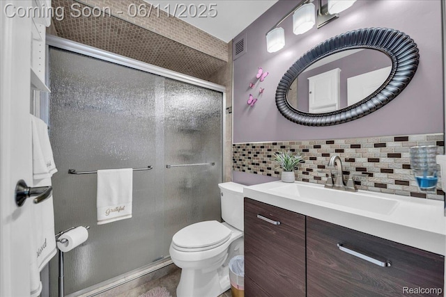 1001 W Jefferson Ave Unit 2I, Detroit, MI 48226 - bathroom with toilet, vanity, a shower stall, and tasteful backsplash