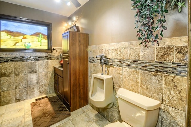5379 N Irish Rd, Davison, MI 48423 - bathroom with tile walls, vanity, toilet, a bidet, and tile patterned floors