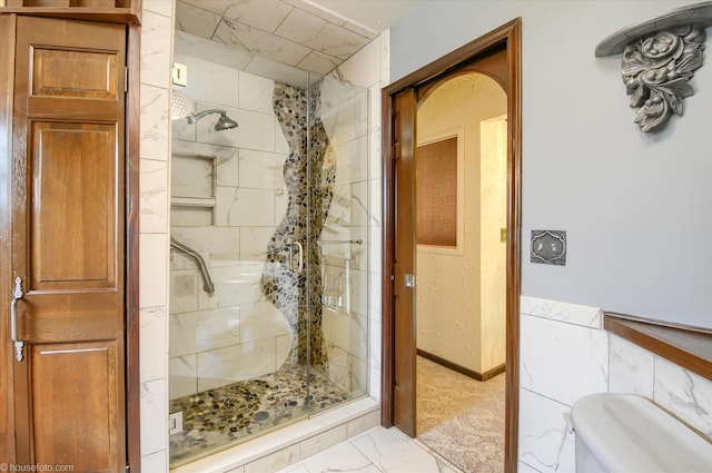 5379 N Irish Rd, Davison, MI 48423 - bathroom with marble look tiles, a stall shower, and toilet