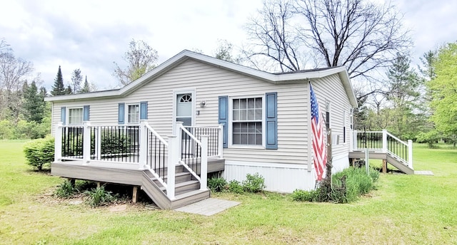 8326 S Delaware Ave, Baldwin, MI 49304 - manufactured / mobile home featuring a front lawn and a wooden deck