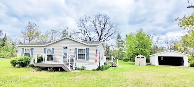 8326 S Delaware Ave, Baldwin, MI 49304 - view of front of house with an outdoor structure, a detached garage, and a front lawn