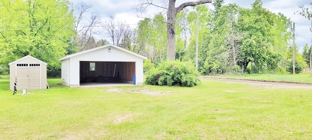 8326 S Delaware Ave, Baldwin, MI 49304 - view of grassy yard featuring an outdoor structure and a detached garage