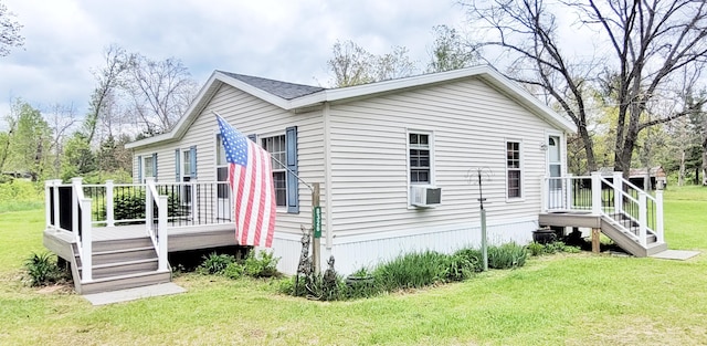 8326 S Delaware Ave, Baldwin, MI 49304 - view of side of home featuring a wooden deck and a lawn